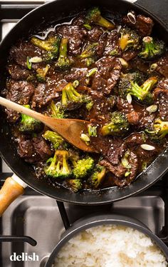 beef and broccoli stir fry in a skillet with rice on the side