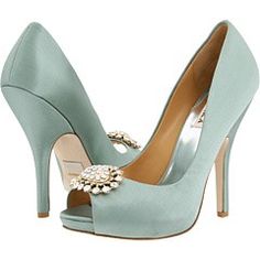 a pair of blue high heels with flowers on the toe and an embellishment