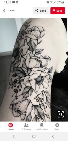 a woman's arm with black and white flowers on the left side of her body