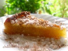 a piece of pie sitting on top of a white plate next to a green bush