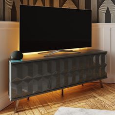 a flat screen tv sitting on top of a wooden cabinet