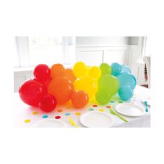 a table topped with lots of balloons and plates