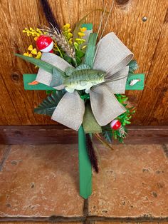 a bouquet made out of paper and some kind of decoration on the front door sill