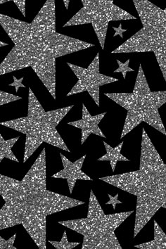 black and silver glitter stars are arranged in the shape of an abstract pattern on a dark background