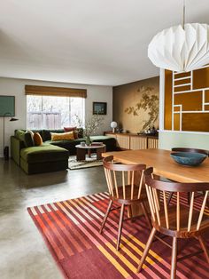 a living room filled with furniture and a wooden table