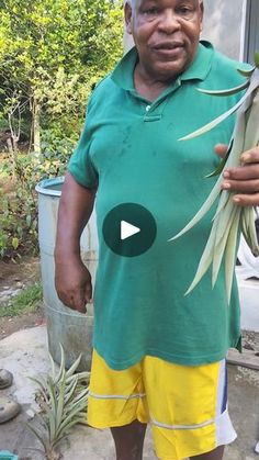 an older man holding a plant in his hand and wearing yellow shorts on the other side