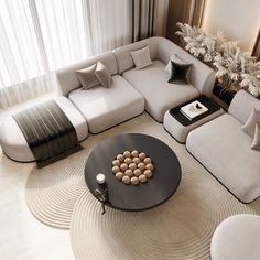 a living room filled with lots of furniture next to a tall white tree in the corner