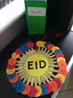 a colorful paper plate with the word ed on it next to a green gift bag