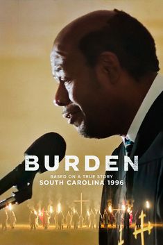 a man standing in front of a microphone with the words burden written on it's side