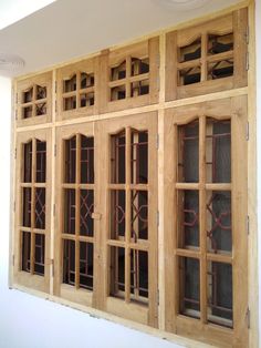 a wooden window with metal bars on the sides and glass panes in front of it