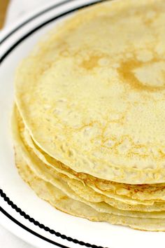 a stack of tortillas sitting on top of a white plate