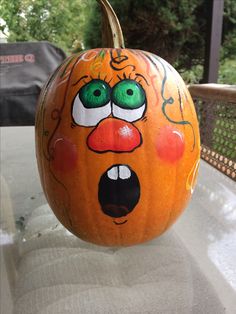 a pumpkin with an angry face painted on it