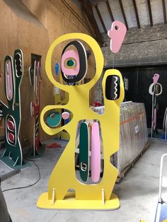 a yellow sculpture sitting inside of a garage