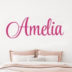 a bedroom with a bed and wall decal that says'amelie'in pink