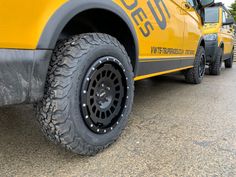 a yellow truck parked on the side of a road