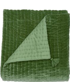 a green blanket with a triangle on it