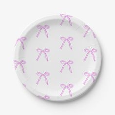 a paper plate with pink bows on the front and back of it, against a white background