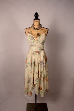 Lovely vintage 70's 80's beige floral summer dress with spaghetti straps and cute diagonal skirt accent!  Beautiful dress by 'Trolley Car', and in great condition! Bust:32" very approximately Waist:26" Hips:Open Length:47" approx Label:  Trolley Car Necklace not included. 3372 Car Necklace, Floral Summer Dress, Hip Openers, Floral Dress Summer, Dress Clothes For Women, Beautiful Dress, Vintage 70s, Summer Dress, Beautiful Dresses