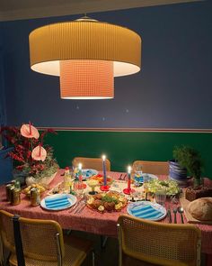 a dining room table set with food and candles