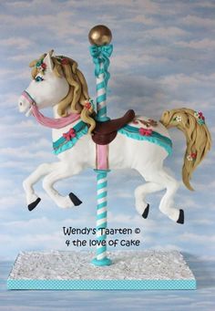 a carousel horse figurine on a blue and white background with the words wendy's thanten 4 the love of cake