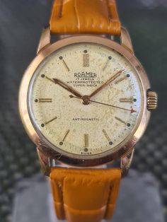 Men's 1960s Vintage Rose Gold Plated ROAMER Super Shock 17 Jewel Mechanical Watch Swiss made. Cal. MST 372 The case is in excellent vintage condition.  Any marks or scratches are commensurate with age and use and do not affect usage.  see photos for full condition. The ivory coloured dial is in good vintage condition The hour and minute hands and hour markers are in gold tone with centre sweep seconds. See photos. The case measures approx 34 mm excluding the signed crown. The acrylic crystal is Super Shock, Vintage Rose Gold, Light Brown Leather, Brown Leather Strap, Mens Vintage, Vintage Rose, Wristwatch Men, Mechanical Watch, Watch Collection