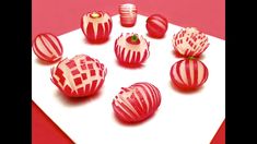 red and white striped candy apples sitting on top of a paper towel next to each other