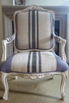 an old chair with blue and white stripes on it