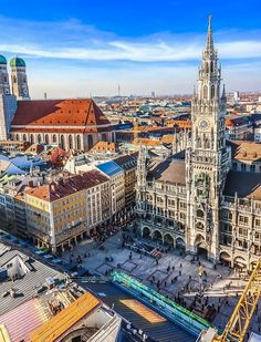 an aerial view of a city with tall buildings and many spires in the center