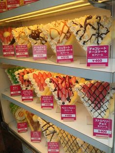 a display case filled with lots of different types of desserts and toppings on top of each other