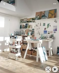 an artist's studio with easels and paintings on the wall