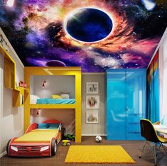 a bedroom with a space theme painted on the ceiling