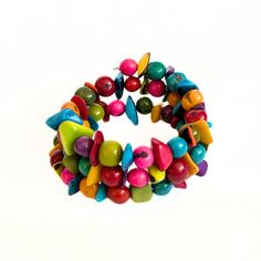 a bunch of colorful beads are arranged in the shape of a wreath on a white background