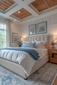 a large white bed sitting in a bedroom next to two windows