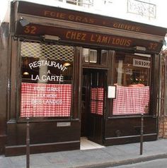 a restaurant called la carte with red and white checkered tablecloths on the windows