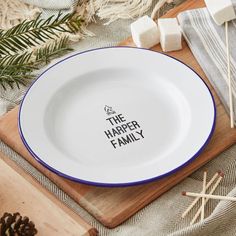 a white plate with the words the harper family on it next to marshmallows