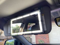 the interior of a car with a mirror on it's dash board and lights