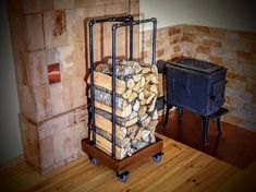 a stack of logs sitting on top of a wooden floor next to a heater