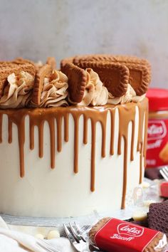 a close up of a cake with icing and cookies on the top, along with other desserts