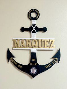 an anchor with the word marquee on it and two black anchors attached to it