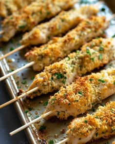 chicken skewers on a baking sheet with parmesan cheese and seasoning