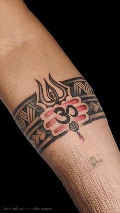 a man's arm with a tattoo design on it