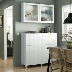 a dining room and kitchen area with blue walls