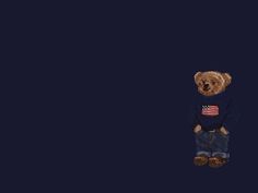 a teddy bear wearing an american flag sweater and jeans standing in front of a dark blue background