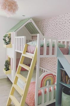 a child's bedroom with bunk beds and a ladder to the top floor, in pastel colors