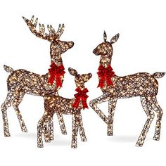 two christmas reindeers with red bows on their heads are standing next to each other