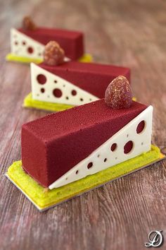 two pieces of cake sitting on top of a wooden table