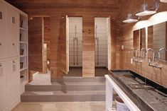 a bathroom with wooden walls and two sinks