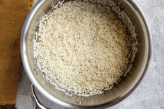 rice in a pot with a cloth next to it