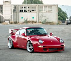 a red sports car parked in an empty parking lot