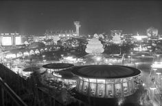 an aerial view of the city at night, with lights and buildings in the background